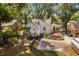 Aerial view of a manicured backyard with lush lawn, patio, and charming home exterior at 3210 Merriman Ave, Raleigh, NC 27607