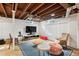 Finished basement featuring a cozy entertainment area and exposed wood ceiling at 3210 Merriman Ave, Raleigh, NC 27607