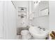 Classic bathroom featuring a pedestal sink, built-in shelving, and vintage-style black-and-white tile flooring at 3210 Merriman Ave, Raleigh, NC 27607