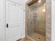 Bathroom features a glass-enclosed shower with tile surround and modern fixtures at 3210 Merriman Ave, Raleigh, NC 27607