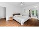 Spacious primary bedroom with hardwood floors, ceiling fan, and bright natural light at 3210 Merriman Ave, Raleigh, NC 27607