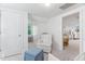 Bright bedroom with carpet features a comfortable armchair and ottoman and a charming baby crib by the window at 3210 Merriman Ave, Raleigh, NC 27607