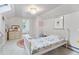 Bright bedroom features a soft color palette, hardwood floors, a skylight, and a cozy quilt bed at 3210 Merriman Ave, Raleigh, NC 27607