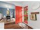 Inviting entryway featuring a red door, hardwood floors, and a view into the dining room at 3210 Merriman Ave, Raleigh, NC 27607