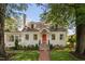 Charming two-story home featuring a red front door, brick walkway, and well-manicured lawn at 3210 Merriman Ave, Raleigh, NC 27607