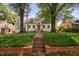 Charming home with a red brick pathway leading to the front door, surrounded by lush landscaping at 3210 Merriman Ave, Raleigh, NC 27607