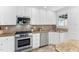 Bright kitchen features stainless steel appliances, granite countertops, and white cabinetry at 3210 Merriman Ave, Raleigh, NC 27607