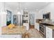 Open kitchen featuring stainless steel refrigerator and appliances, granite counters, and bar seating at 3210 Merriman Ave, Raleigh, NC 27607