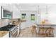 Charming kitchen with breakfast bar, granite counters, stainless appliances, and light fixtures at 3210 Merriman Ave, Raleigh, NC 27607