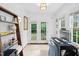 Home office boasts a built-in desk, shelving, and french doors to outdoor space at 3210 Merriman Ave, Raleigh, NC 27607