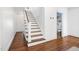 Traditional staircase with wooden steps, white risers, and modern hardwood flooring at 3210 Merriman Ave, Raleigh, NC 27607