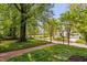 Street view showcases a well-manicured lawn, brick sidewalk, and a serene neighborhood setting at 3210 Merriman Ave, Raleigh, NC 27607