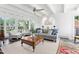 Bright sunroom featuring large windows, comfortable seating, and unique tile flooring at 3210 Merriman Ave, Raleigh, NC 27607