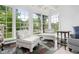 Bright sunroom with large windows providing ample natural light and a comfortable seating area at 3210 Merriman Ave, Raleigh, NC 27607