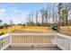 Fenced backyard featuring a wooden deck and playset at 329 Royal Delta Dr, Cary, NC 27519