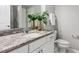 Bathroom featuring granite counters, white cabinets, and decorative plant at 329 Royal Delta Dr, Cary, NC 27519