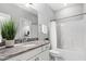 Bathroom featuring a granite countertop with a single sink vanity and a tub and shower combo with a white shower curtain at 329 Royal Delta Dr, Cary, NC 27519