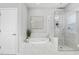 Elegant bathroom featuring a soaking tub and a seamless glass shower with marble tiling and rainfall shower head at 329 Royal Delta Dr, Cary, NC 27519
