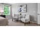 Comfortable bedroom with two accent chairs, neutral carpet, and modern decor accents at 329 Royal Delta Dr, Cary, NC 27519