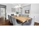 Open-concept dining room with stylish gray chairs, a modern light fixture, and ample natural light at 329 Royal Delta Dr, Cary, NC 27519
