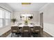 Formal dining room featuring a marble table, elegant chairs, modern lighting, and wainscoting at 329 Royal Delta Dr, Cary, NC 27519
