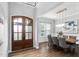 Elegant dining room with a modern light fixture, large windows, and hardwood floors at 329 Royal Delta Dr, Cary, NC 27519