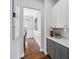 Hallway featuring a cabinet and gray countertop, leading to dining room with wainscoting at 329 Royal Delta Dr, Cary, NC 27519