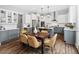Bright kitchen with an island, stainless appliances, and dining area with modern table and chairs at 329 Royal Delta Dr, Cary, NC 27519