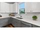 Kitchen featuring a white subway tile backsplash, gray cabinets, quartz countertops, and stainless steel appliances at 329 Royal Delta Dr, Cary, NC 27519