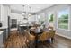 Open kitchen and dining area with island seating and backyard view at 329 Royal Delta Dr, Cary, NC 27519