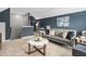 Cozy living room features a contemporary-style sofa and two accent chairs, complemented by a marble coffee table and blue accent wall at 329 Royal Delta Dr, Cary, NC 27519