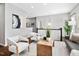 Bright living room featuring hardwood floors, a stylish gray sofa, and a wooden coffee table at 329 Royal Delta Dr, Cary, NC 27519