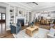 Open-concept living room featuring hardwood floors, a fireplace, and a view of the kitchen and dining area at 329 Royal Delta Dr, Cary, NC 27519