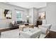 Bright living room featuring gray sofa, modern decor, and hardwood floors throughout the space at 329 Royal Delta Dr, Cary, NC 27519