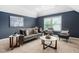 Bright living room features a comfortable gray sofa with two accent chairs and a marble coffee table, complemented by natural light at 329 Royal Delta Dr, Cary, NC 27519