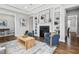 Cozy living room with hardwood floors, fireplace, built-in shelves, and comfortable seating at 329 Royal Delta Dr, Cary, NC 27519