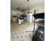 Open kitchen featuring white cabinetry, a dining area, and tiled floors, ready for culinary adventures and gatherings at 333 Park Ave, Rocky Mount, NC 27801