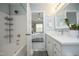 A clean bathroom connected to the bedroom shows a tub and shower combination with white cabinets at 365 Red Elm Dr, Durham, NC 27713