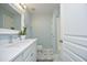 Well-lit bathroom with white vanity, modern fixtures, and decorative floor tiles at 365 Red Elm Dr, Durham, NC 27713