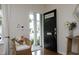 Bright entryway featuring a black door with glass accents, and a charming accent chair at 365 Red Elm Dr, Durham, NC 27713