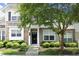 Charming two-story home with stone accents, a black front door, and lush landscaping at 365 Red Elm Dr, Durham, NC 27713