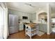 Spacious kitchen features stainless steel appliances, light green cabinetry, and a butcher block island at 365 Red Elm Dr, Durham, NC 27713