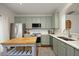 Well-equipped kitchen featuring stainless steel appliances, quartz countertops, and sage cabinets at 365 Red Elm Dr, Durham, NC 27713