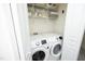 Bright laundry room features a modern Samsung washer and dryer and storage on shelves above at 365 Red Elm Dr, Durham, NC 27713