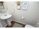 This lovely powder room is decorated with a pedestal sink and stylish art on the walls at 365 Red Elm Dr, Durham, NC 27713