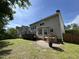 Spacious backyard featuring a deck, brick patio, and partial fencing at 3713 Coach Lantern Ave Ave, Wake Forest, NC 27587