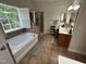 Bright main bathroom with garden tub, glass enclosed shower and double sink vanity at 3713 Coach Lantern Ave Ave, Wake Forest, NC 27587