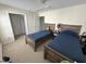 Bedroom featuring two beds, neutral walls, and multiple entry doors at 3713 Coach Lantern Ave Ave, Wake Forest, NC 27587