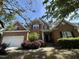 Charming brick home featuring manicured landscaping, a welcoming front porch, and classic architectural details at 3713 Coach Lantern Ave Ave, Wake Forest, NC 27587