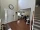 Welcoming foyer with hardwood floors, a staircase, and a view of a chandelier-lit office space at 3713 Coach Lantern Ave Ave, Wake Forest, NC 27587